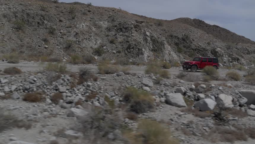 A car is driving through a rural area