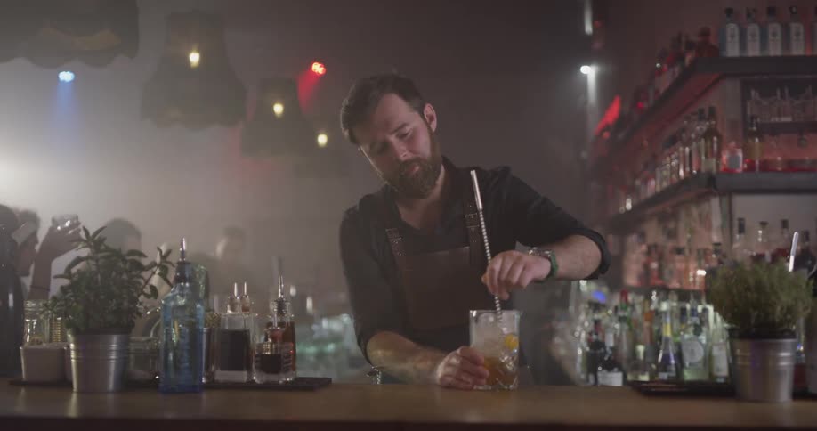 Bartender mixes a large drink