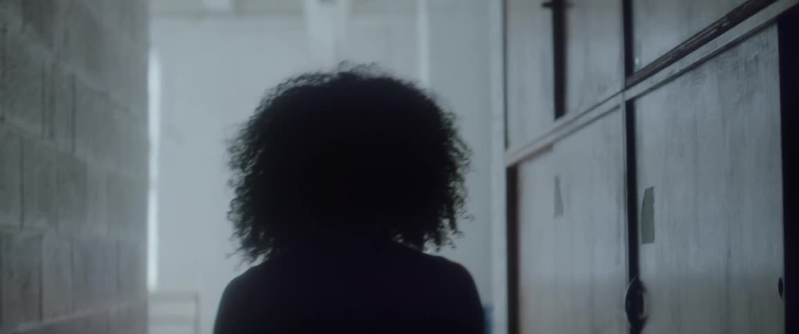 A woman is walking down a hallway