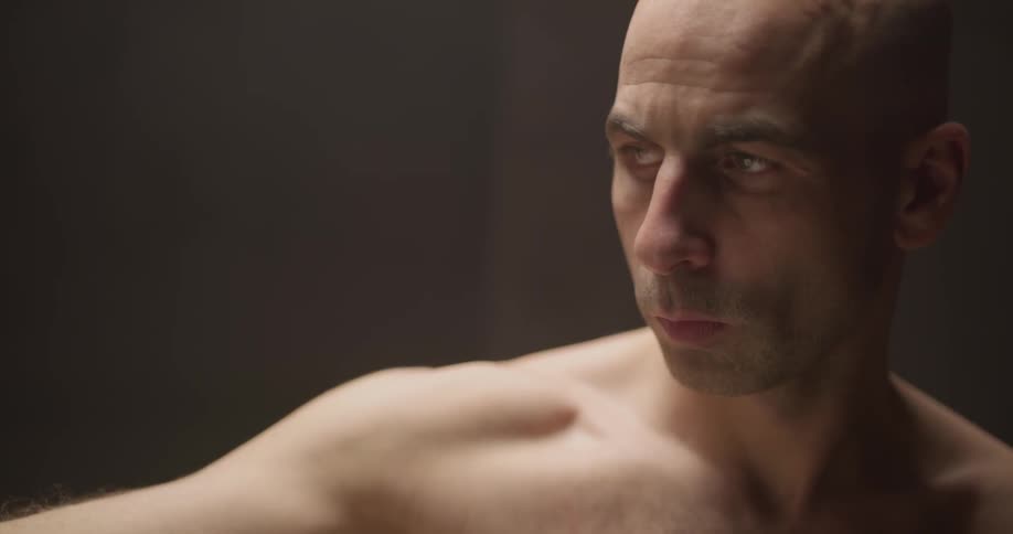 A man is concentrating hard on something in front of him
