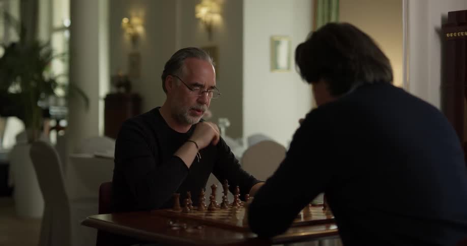Two Men Playing Chess Inside House