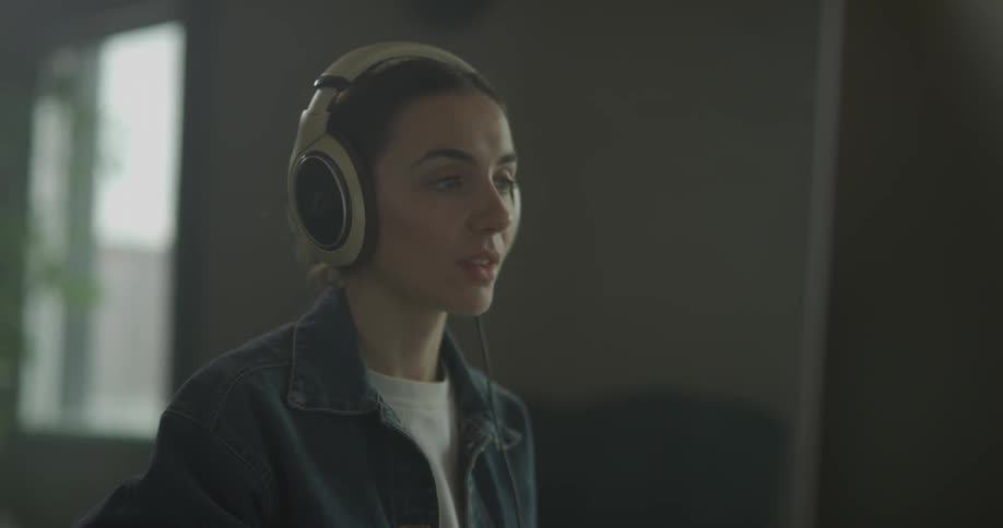 A woman bobs her head to music in her headphones