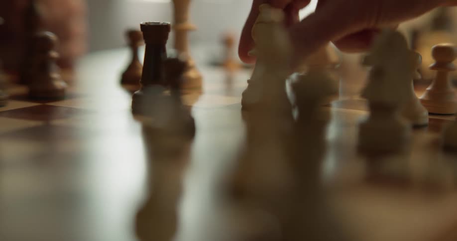 Two people play a game of chess