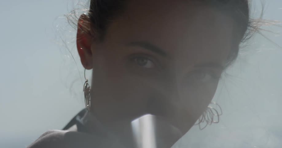A woman relaxes before staring into the camera
