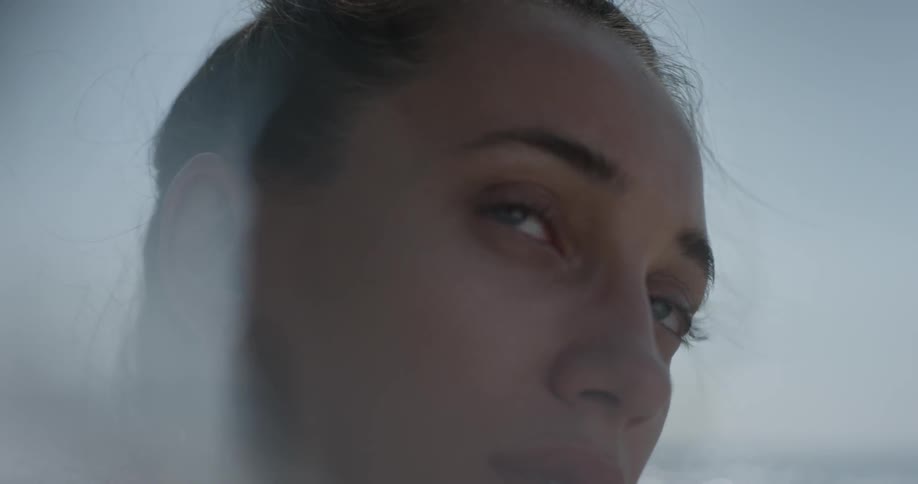 A woman is glancing around outside
