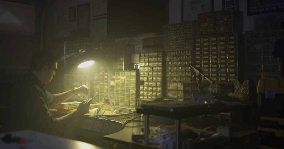Man Soldering In Garage