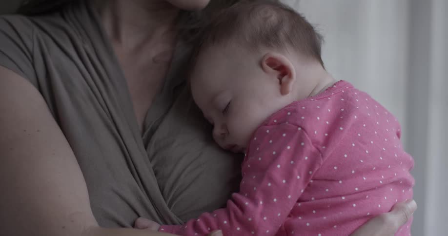 A woman is holding a baby