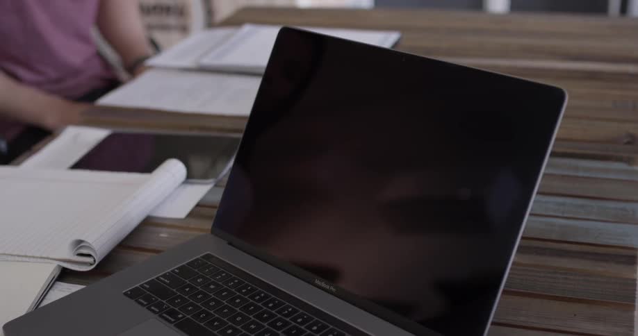 Someone is pointing at a laptop