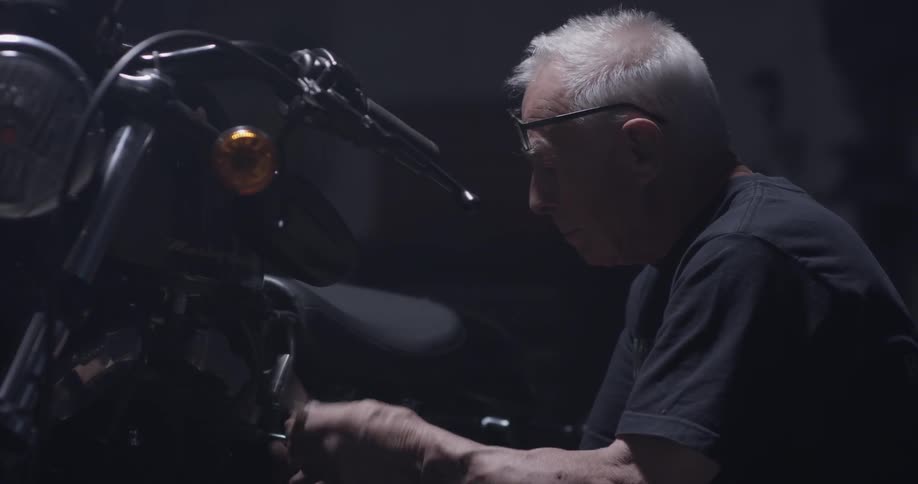 Man adjusts motorcycle part