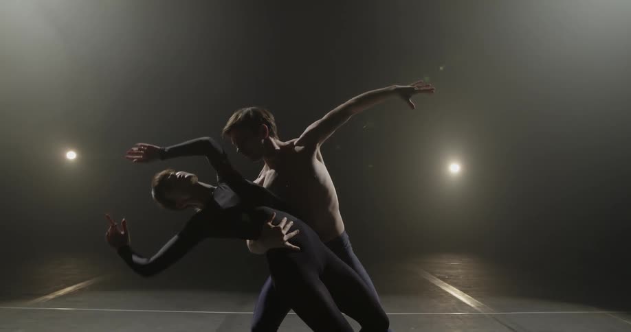 Two dancers preform on stage