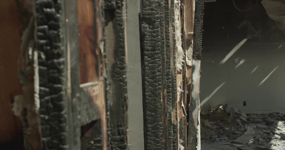 Interior house wall damaged by smoke and fire