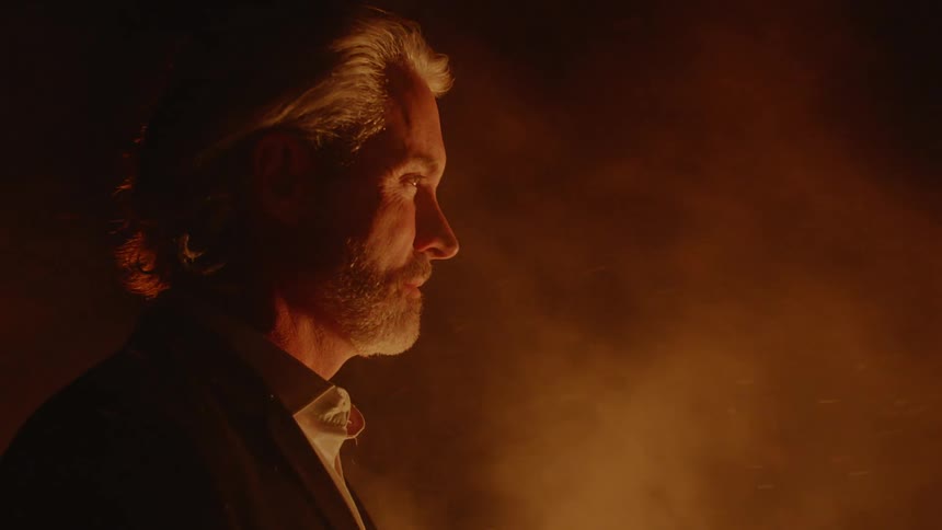 A man is outside by smoke