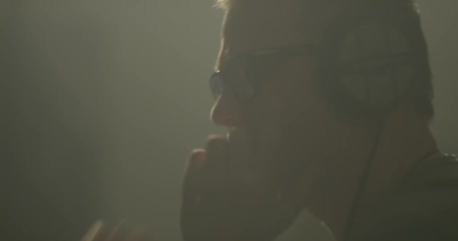 A sound engineer puts on headphones