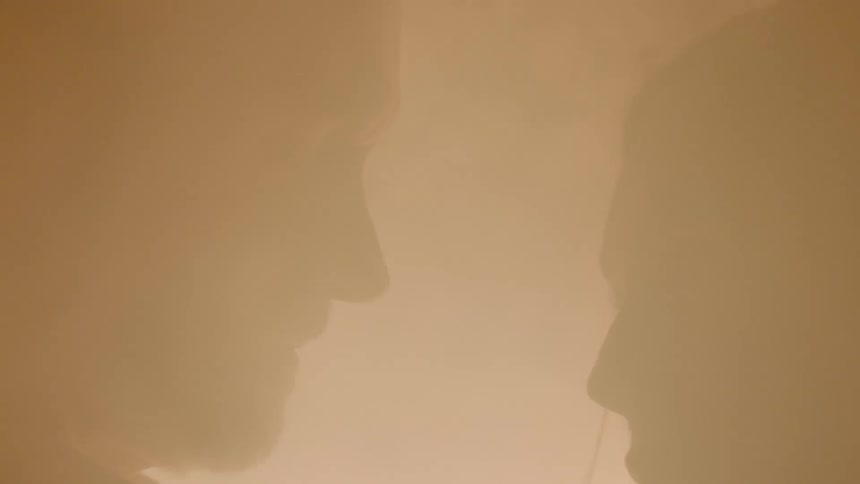 A man and woman are staring at each other