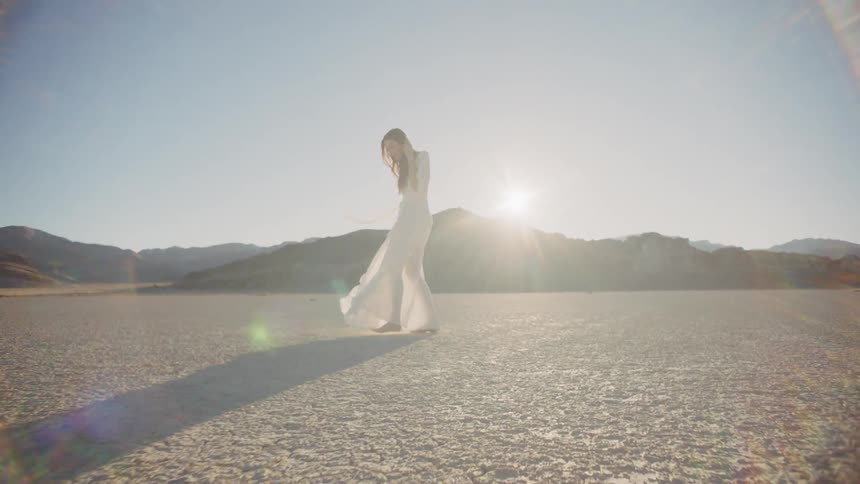 A woman's dress flows in the wind
