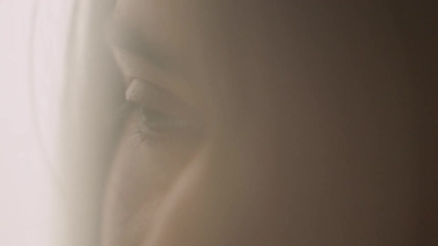 A woman's hair blows away from her face