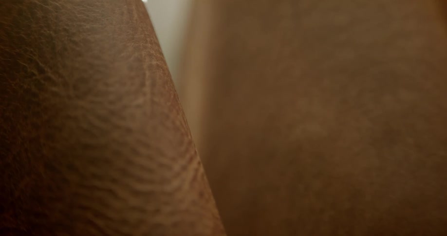 A camera coming into focus showing a piece of leather