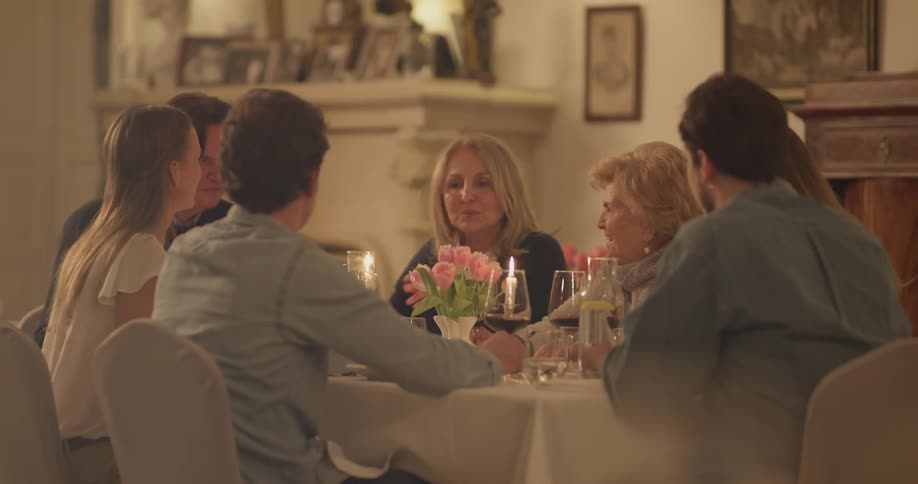 A family sits down while having a conversation at a table