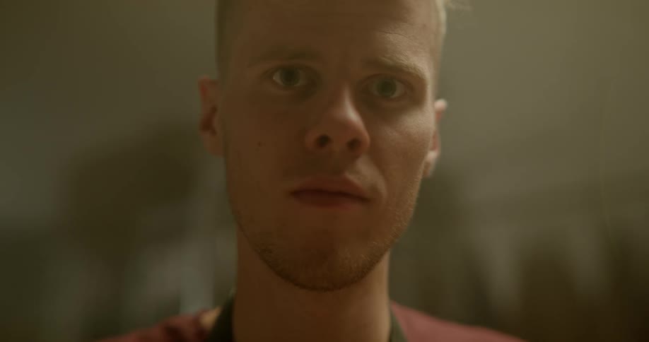 A man is looking around indoors