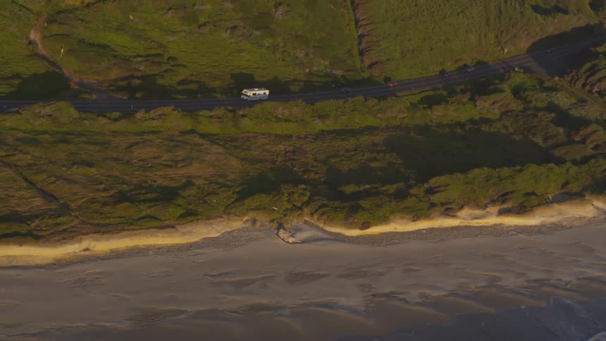 Cars are moving through a field