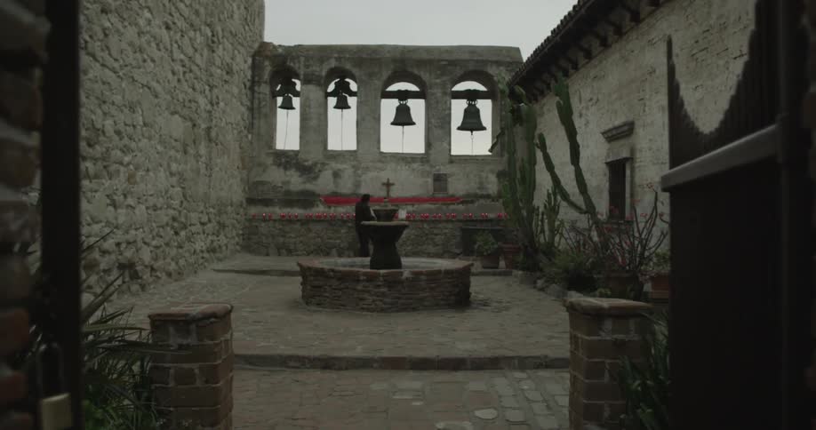 A person standing in a courtyard