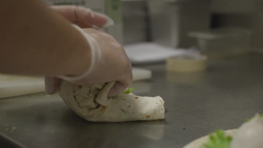A person is folding a wrap