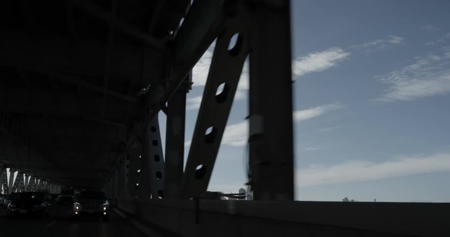 Cars are driving under a bridge