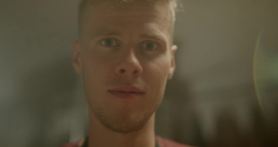 A man is looking around and smiling