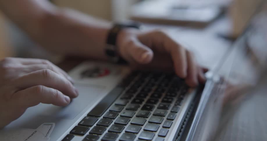 A person scrolls on their laptops touchpad