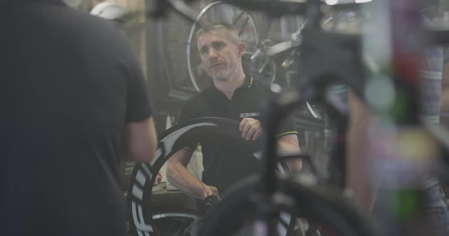 A bicycle shop employee works in the shop