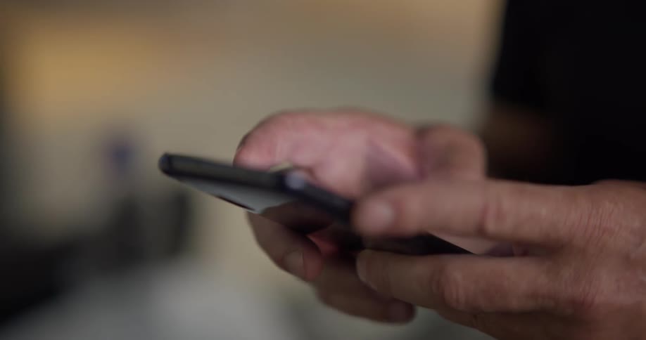 A man scrolls through his phone
