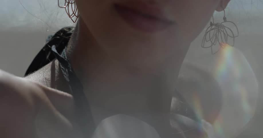 A woman's earrings dangle as she turns her head