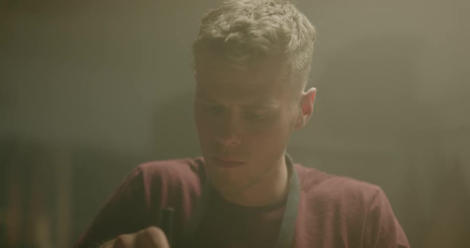 A man uses a mallet and hits something