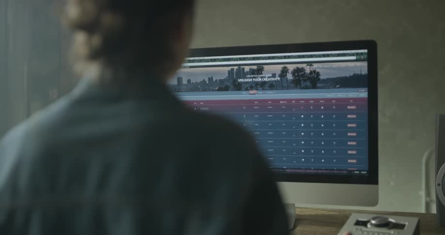 A man is looking at a computer screen indoors