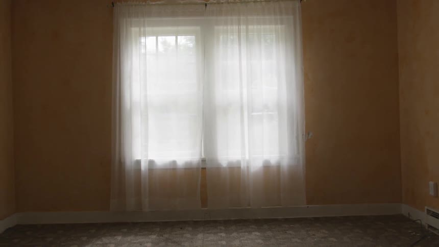 A window covered by a sheer curtain