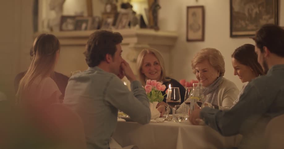 Family gathered around a dinner table with wine