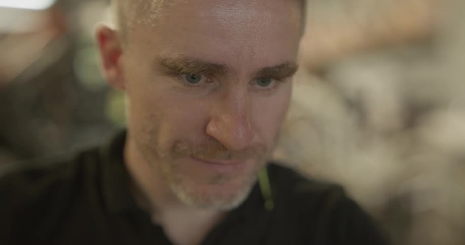 A man is staring and looking around