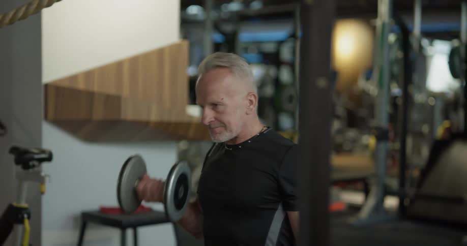 A man is lifting weights at a gym