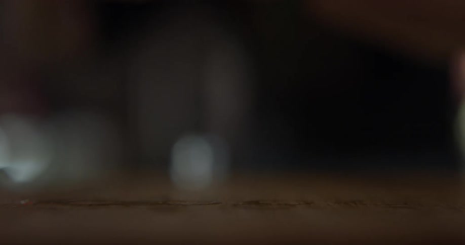 A person picking up shots from a table