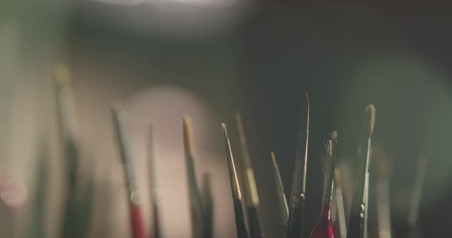 Paint brushes that are sitting in a jar