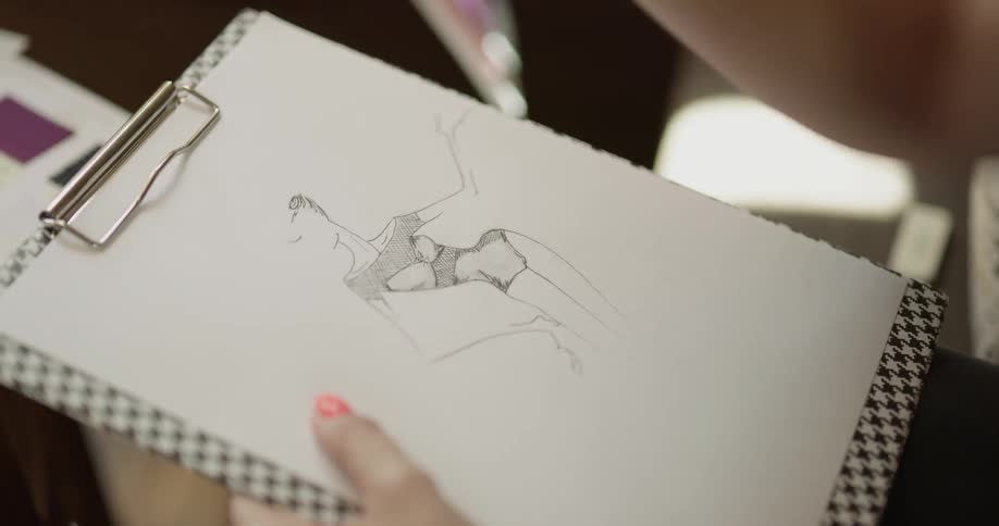 A person sketching on a piece of paper