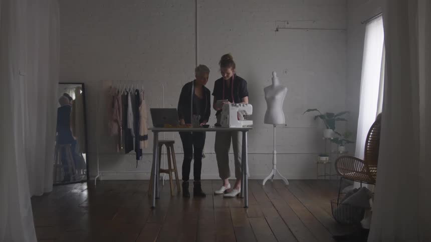 Two people working in a sewing shop