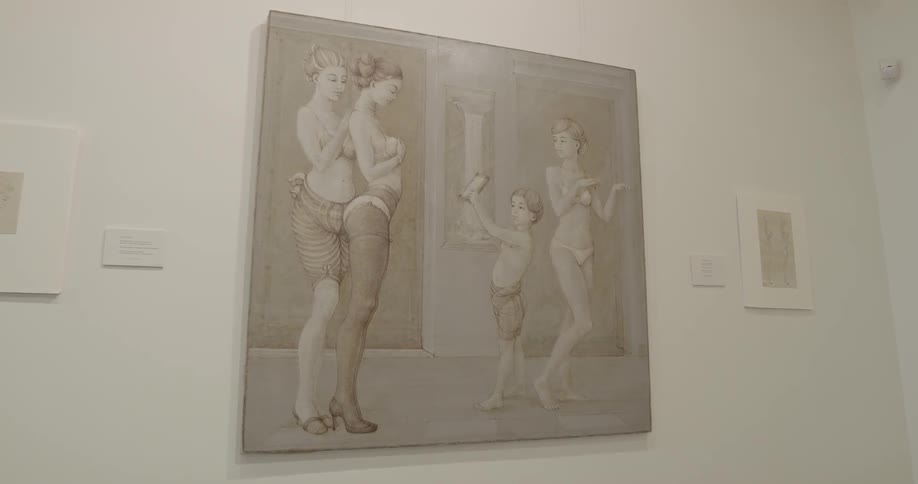 A painting hangs on a wall