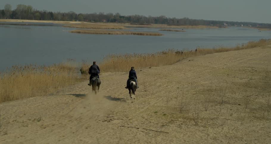 Two people riding horses