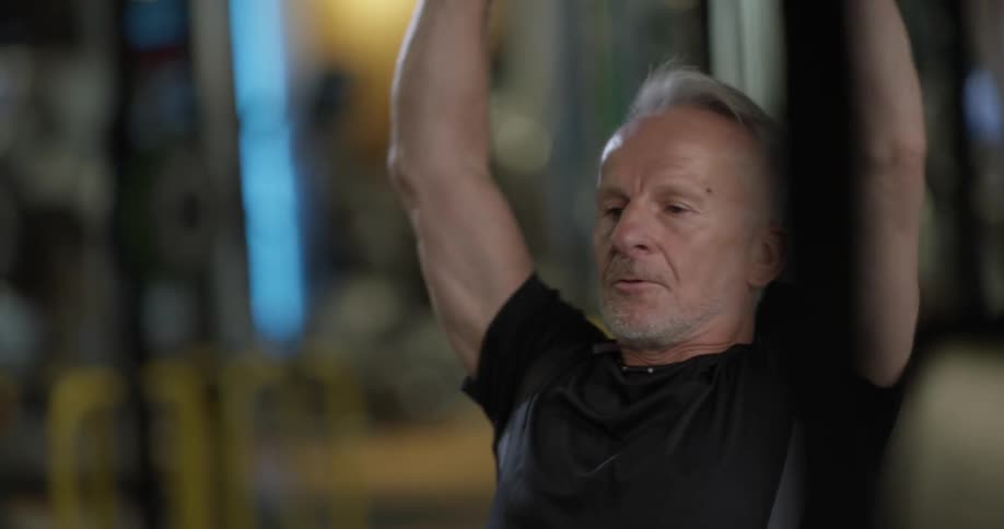 A man is working out while sitting down