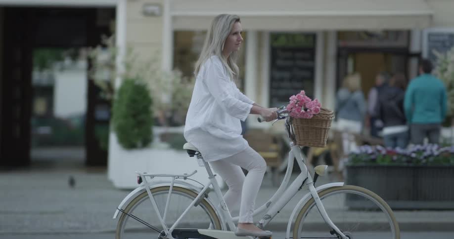 Woman Riding Bike To Coffee Shop