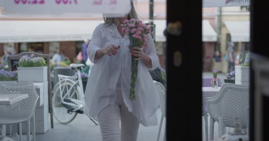 A woman getting flowers out of a basket