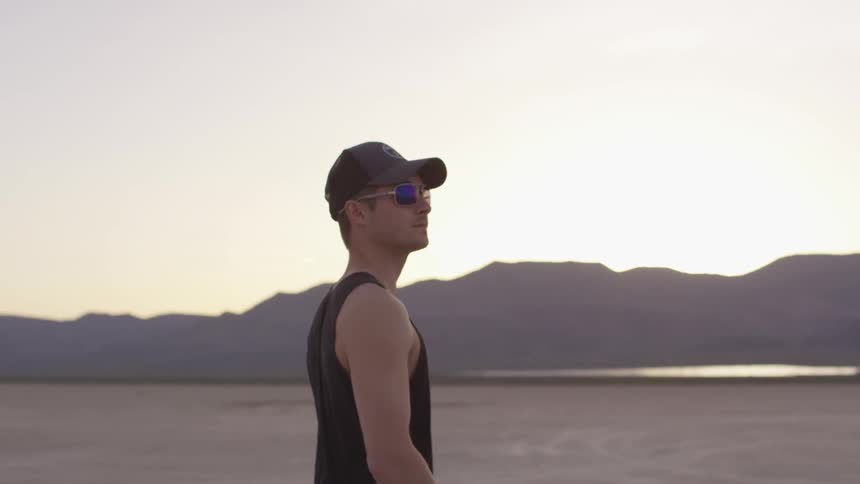 A man walking across a flat ground surface