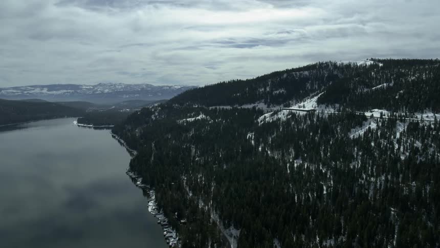 Clouds roll over hills and a river