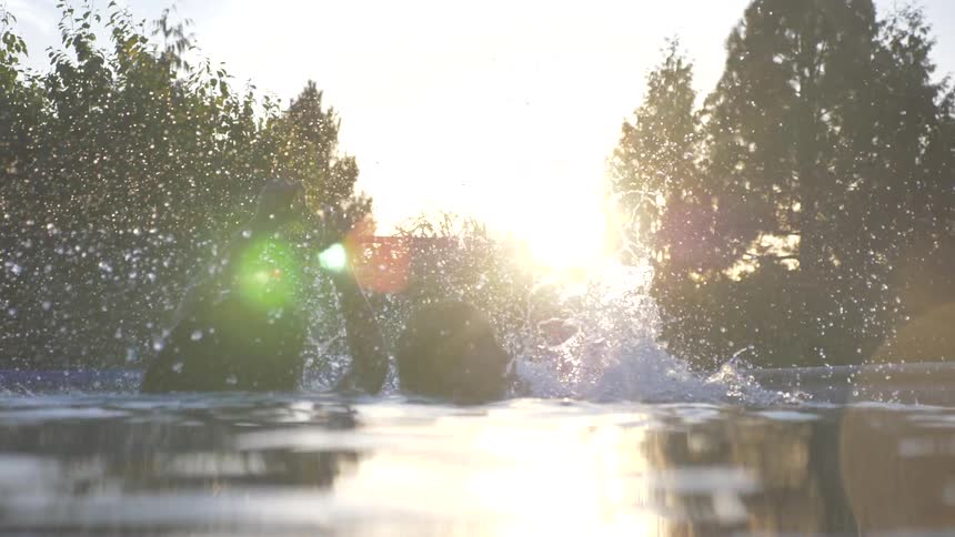 Children jumping into a pool